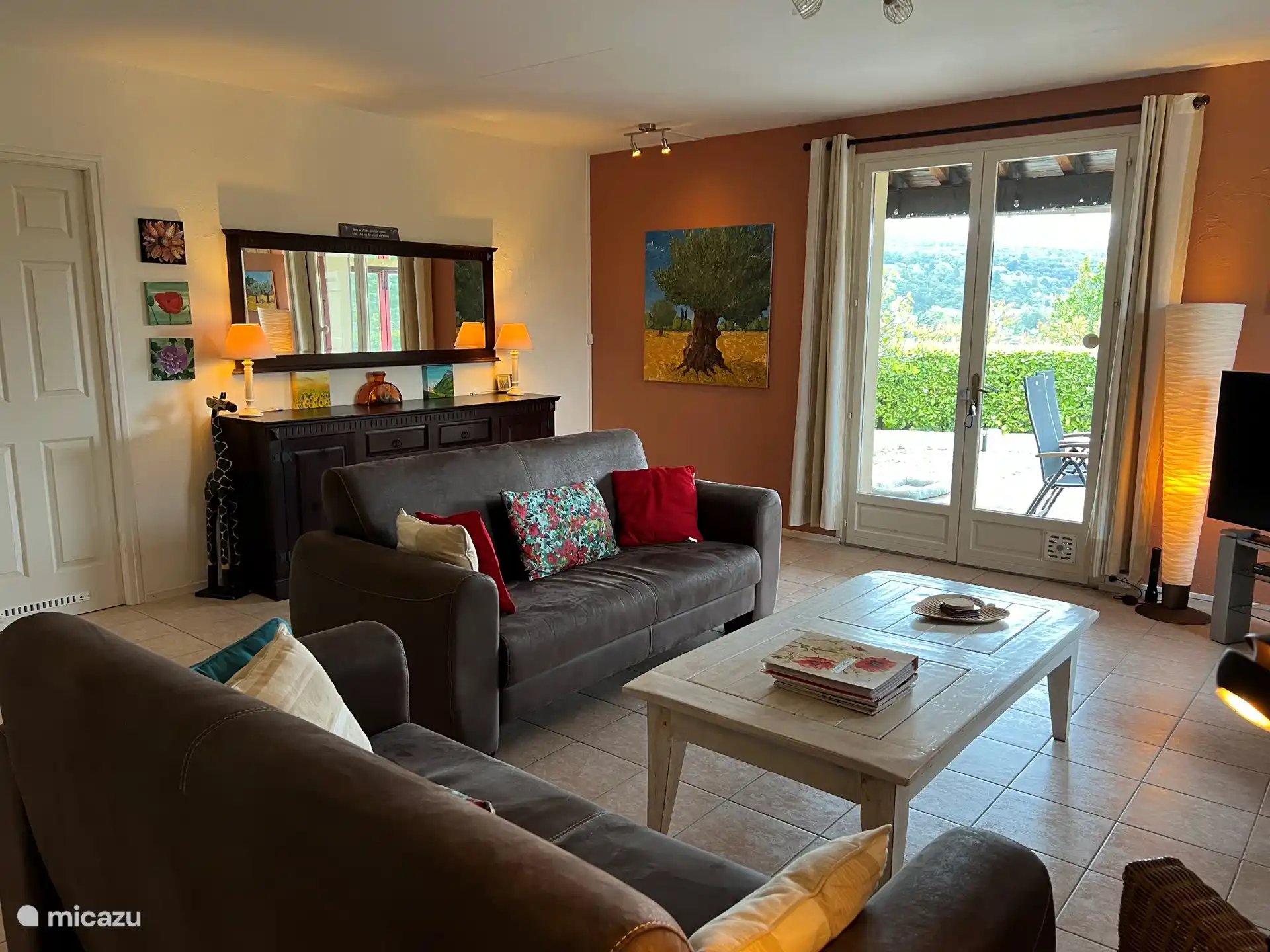 You enter the spacious and cozy living room through the terrace doors