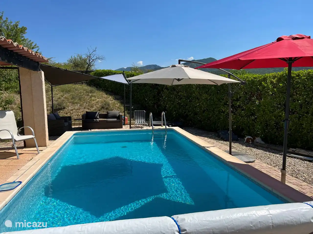 There is plenty of space at the pool to relax. There is also a separate toilet and a screened outdoor shower with cold and hot water.