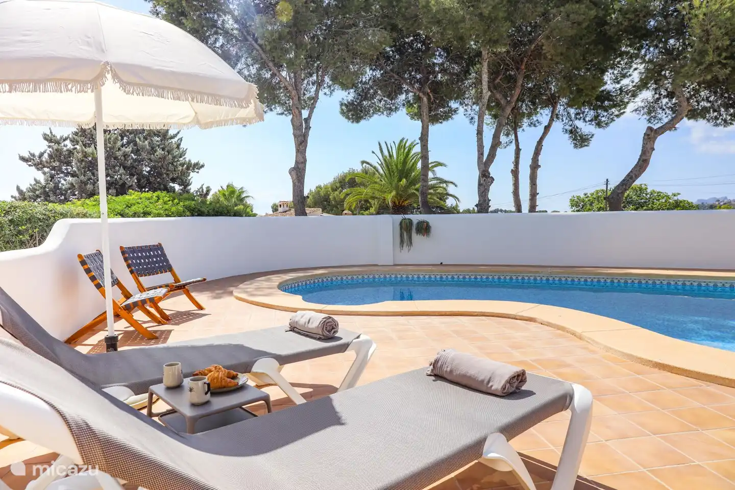 Comfortable sunbeds by the pool