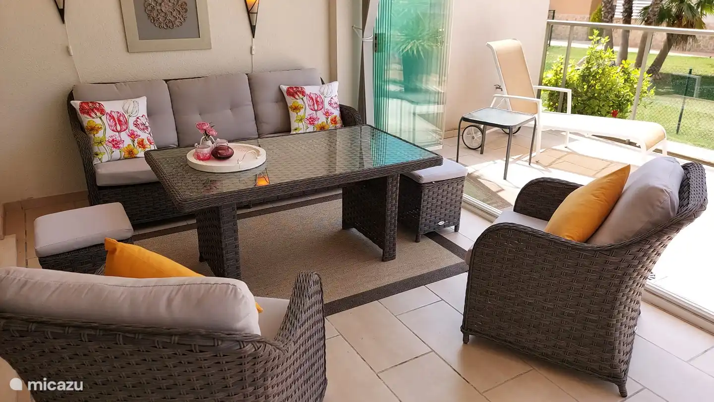 Covered terrace area, with lounge set, can be closed off as a conservatory.