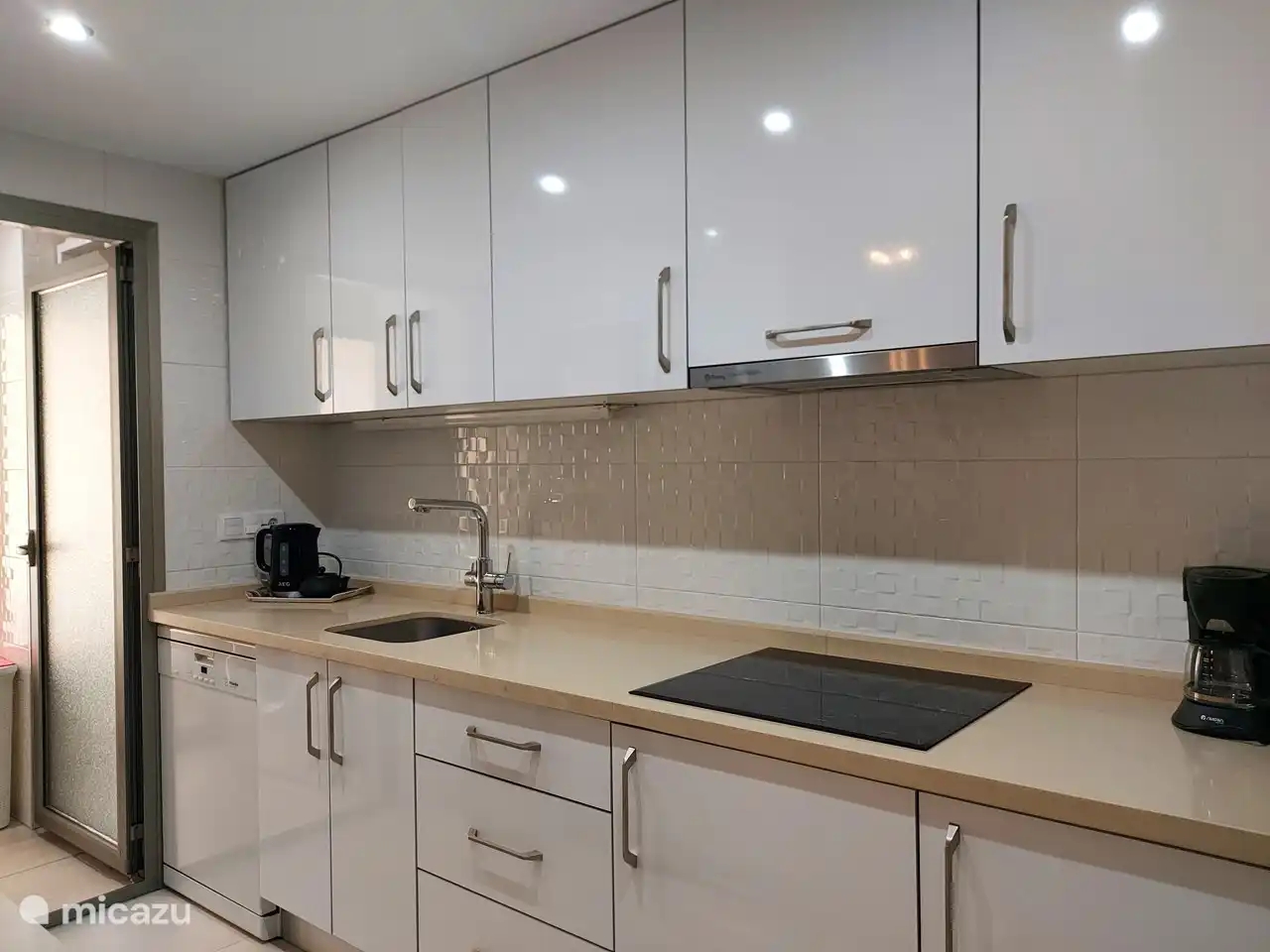 spacious and fully equipped kitchen with all appliances: microwave, oven, refrigerator with freezer, dishwasher, coffee maker, kettle, toaster. Washing machine and hot water boiler with heat pump in adjacent laundry kitchen.