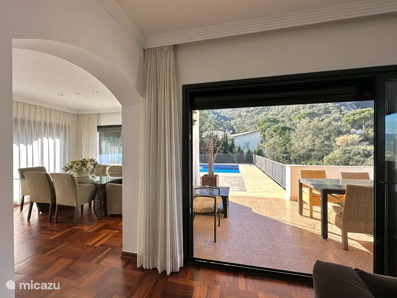 Façade vitrée avec accès à la terrasse et à la piscine