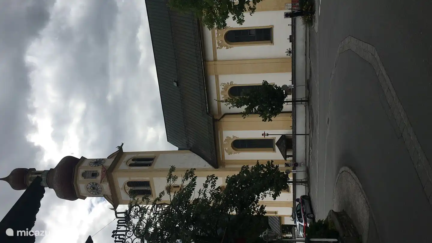 The center of Fulpmes with the church and the bus stop to the ski area Schlick 2000. In front of the door.