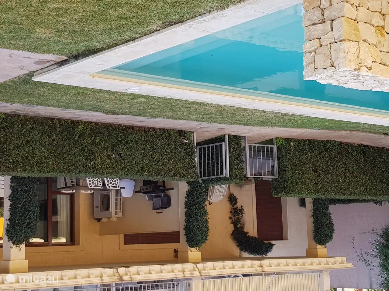 The swimming pool is right in front of the apartment