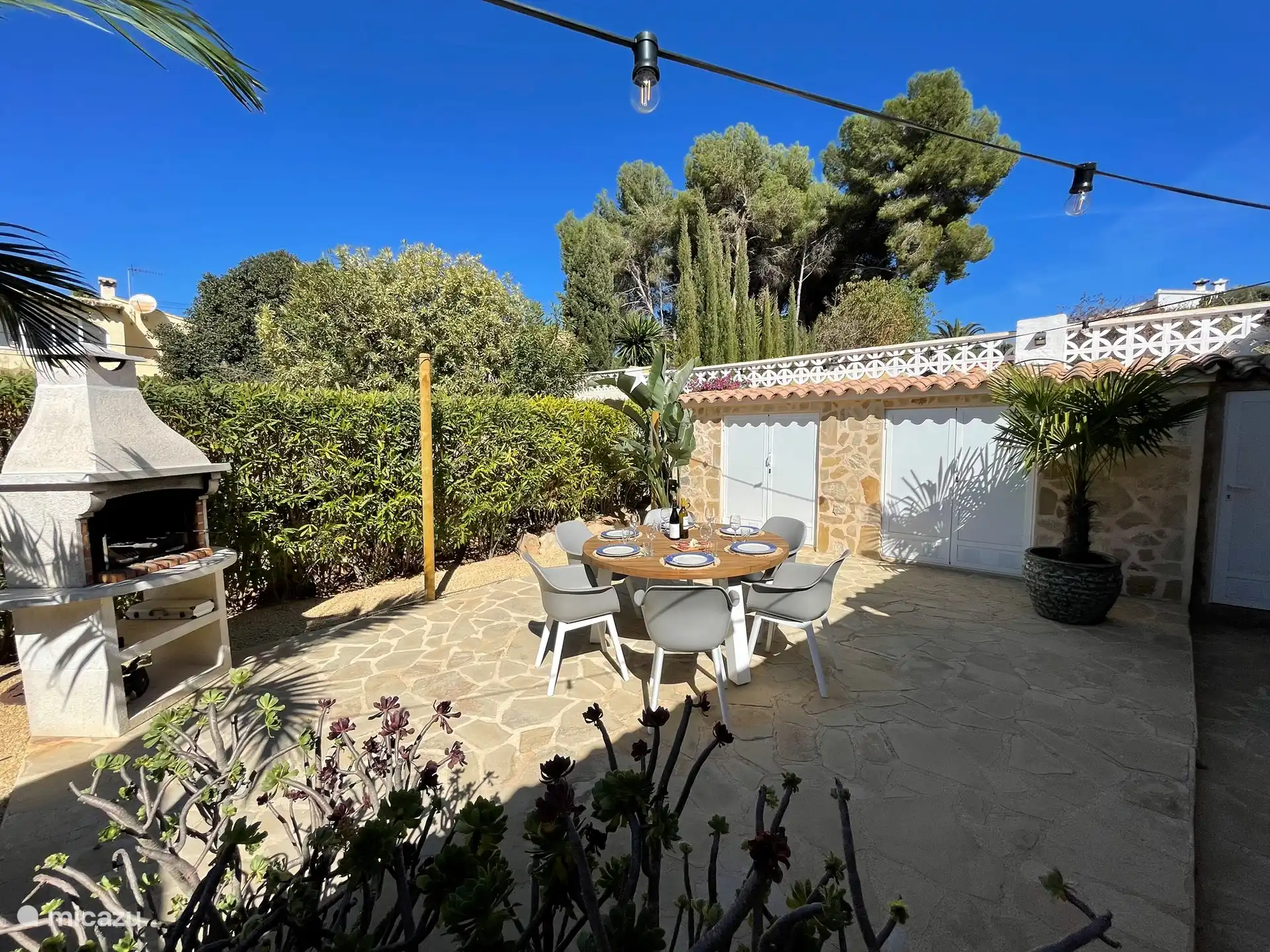 Backyard terrace with BBQ and lovely garden furniture
