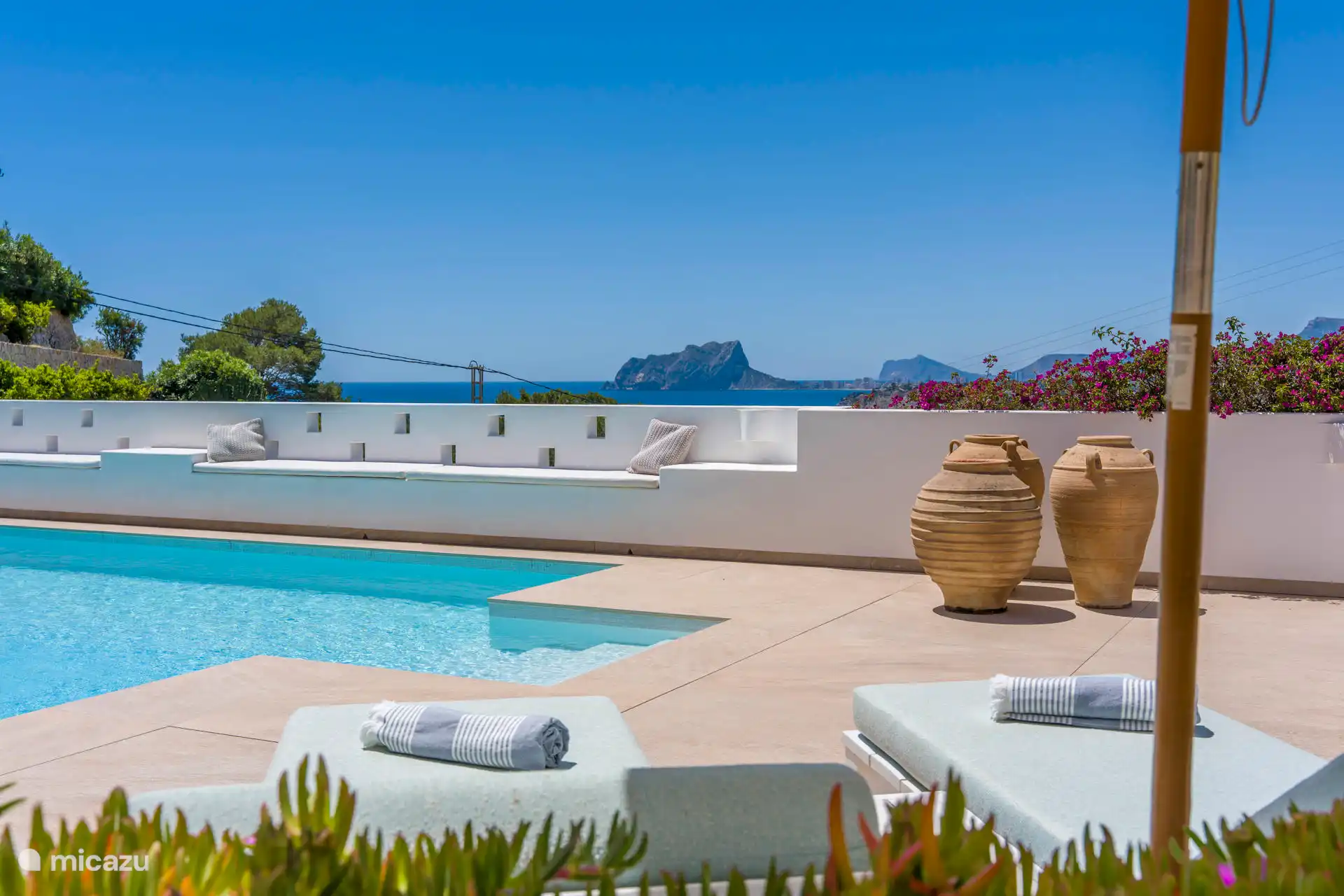 The other two sunbeds are poolside.