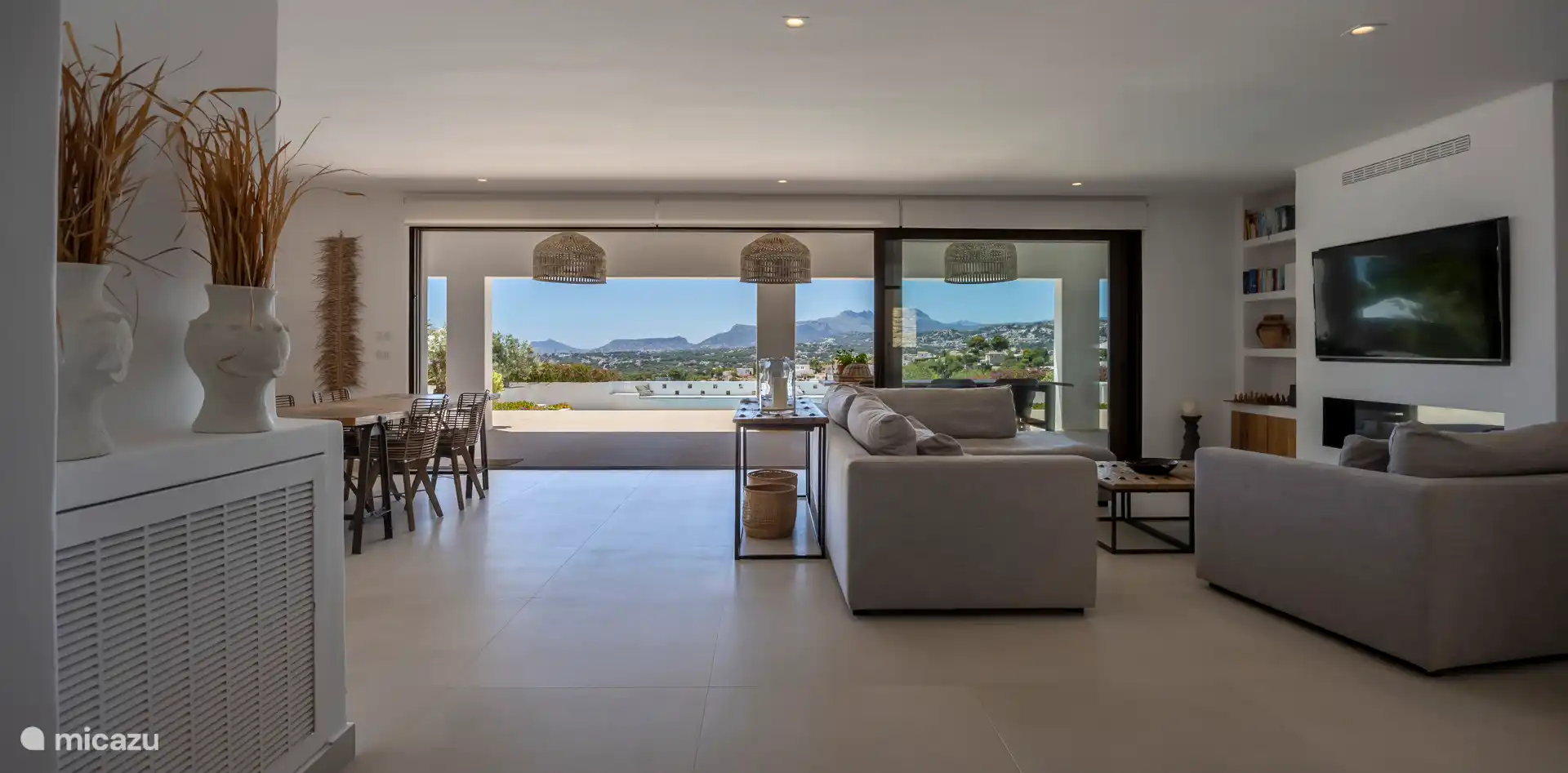 The living room can be seen from the outside door with a three-part sliding door