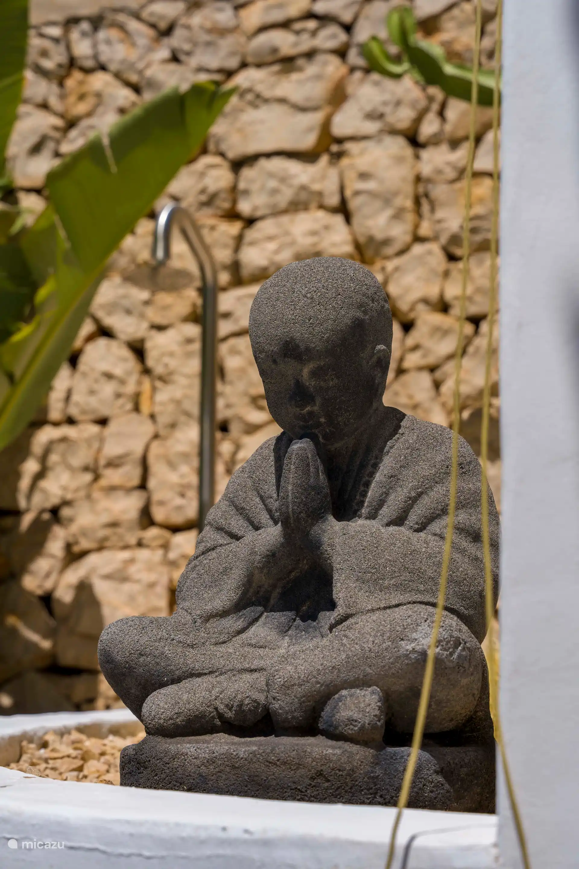 Our Buddha with the outdoor shower behind it with hot water