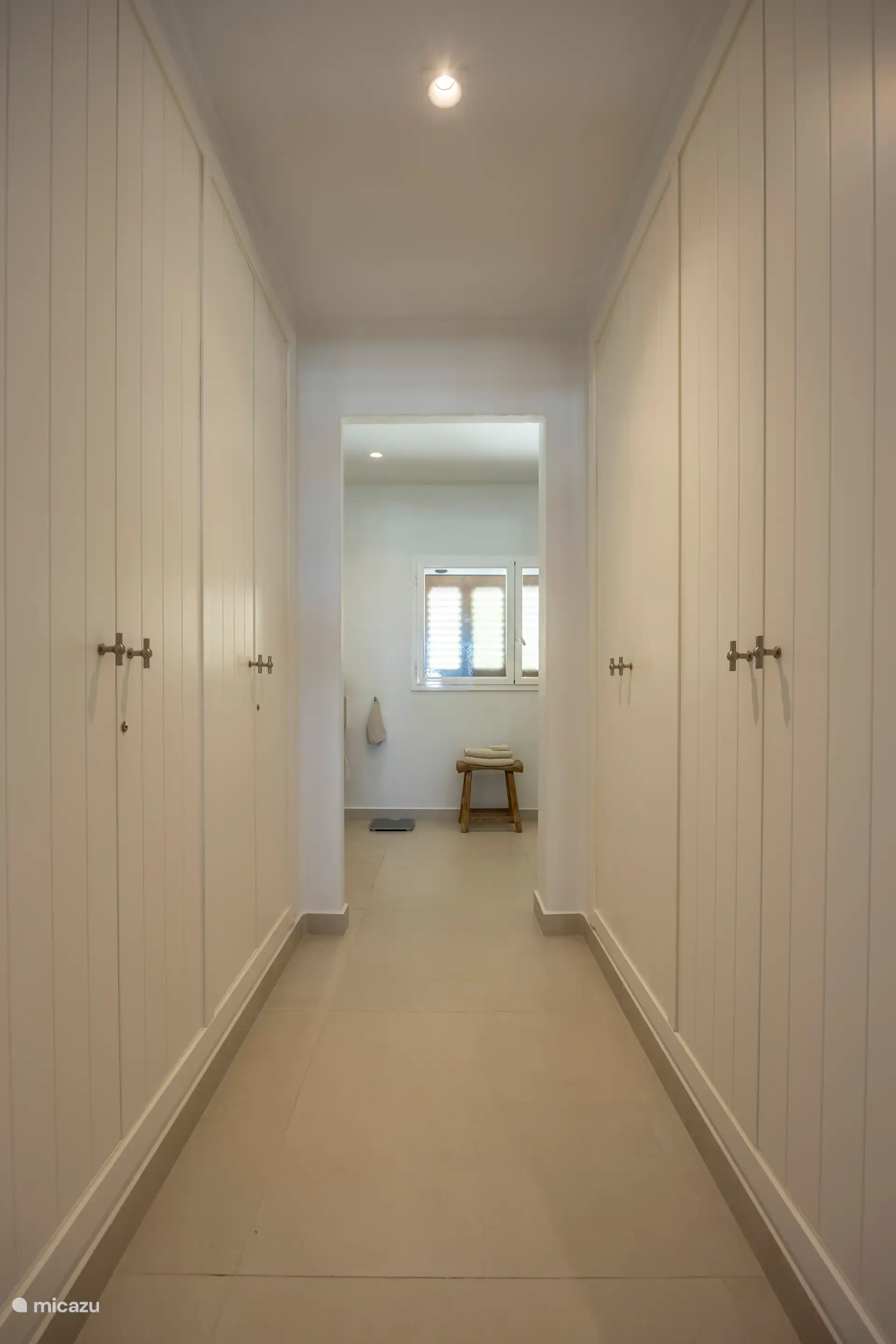 The wardrobes in the passage from master bedroom to bathroom
