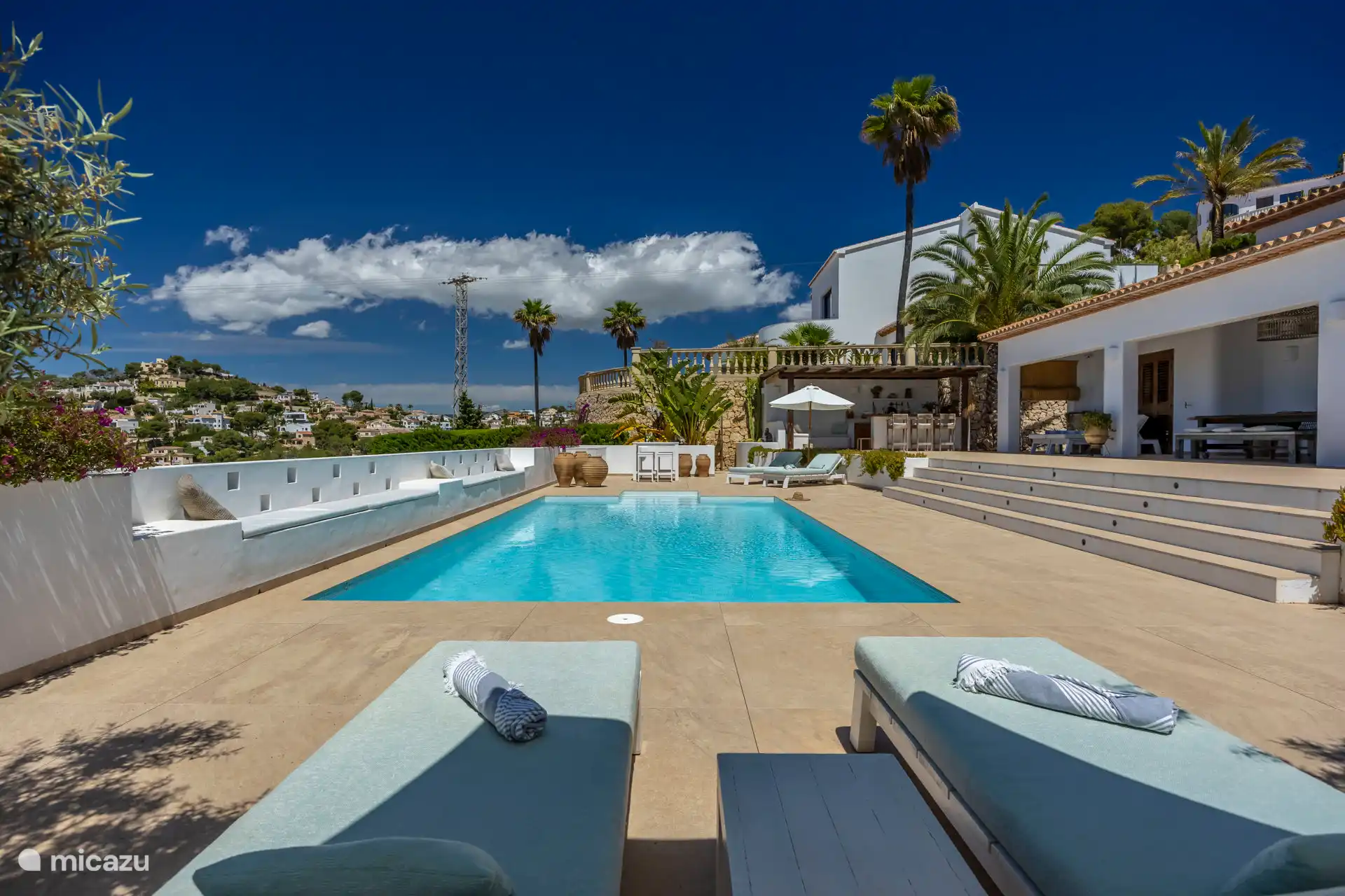 The sunbeds with a view over the pool.