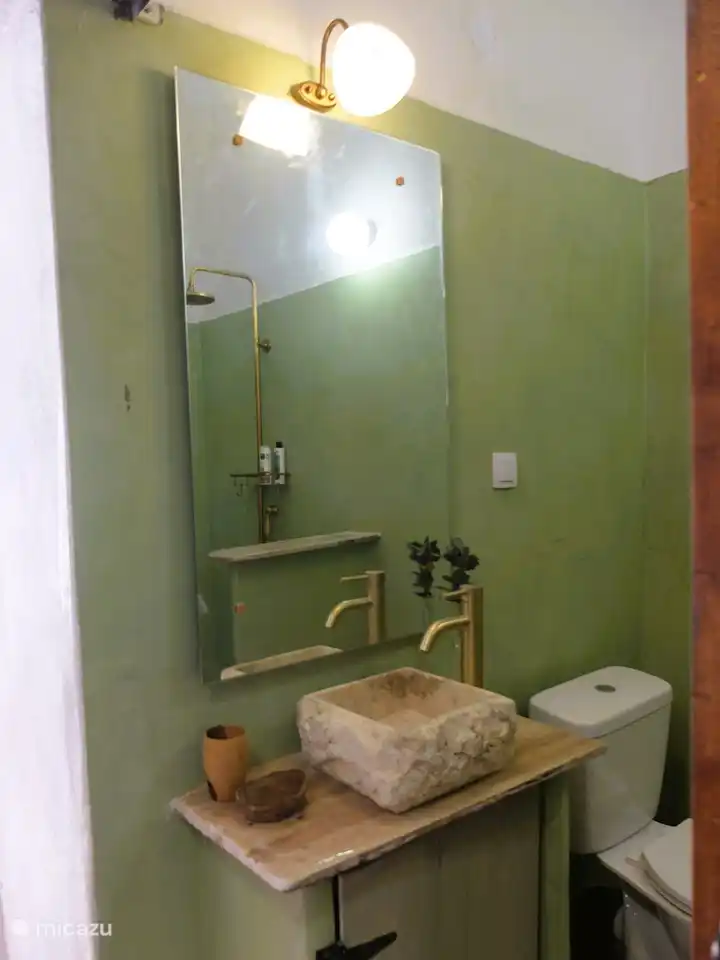 Bathroom with handmade natural stone sink.