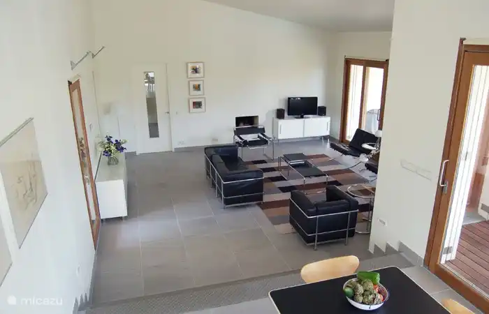 The living room is a large high modern space for 8 people.