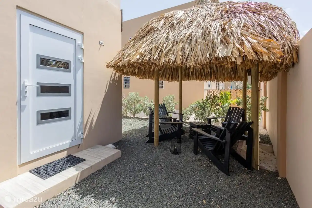 Palapa met tafel en vier stoelen om rustig te kunnen genieten onder een overkapping