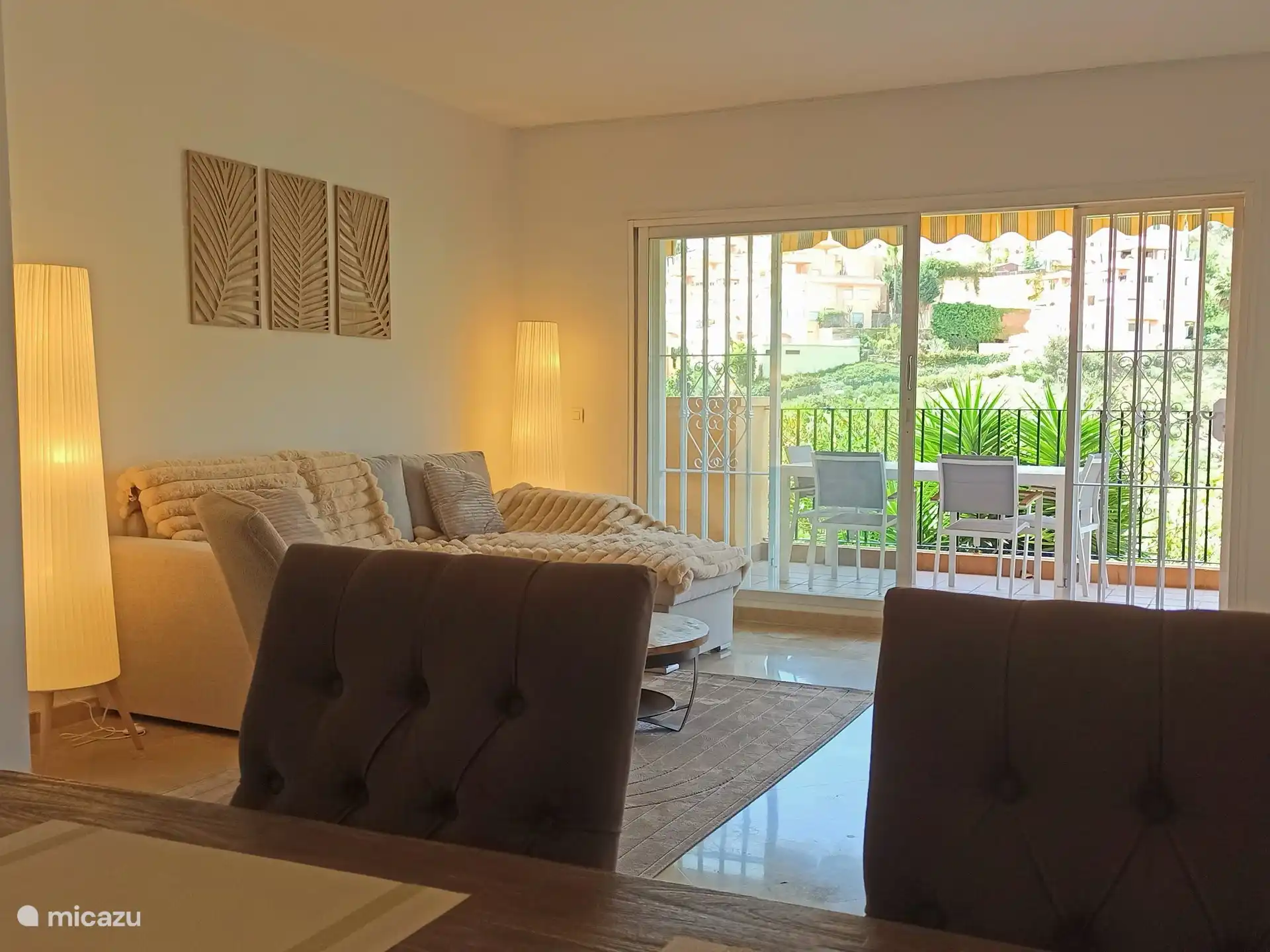 the living room with a comfortable lounge sofa and a view of the hills