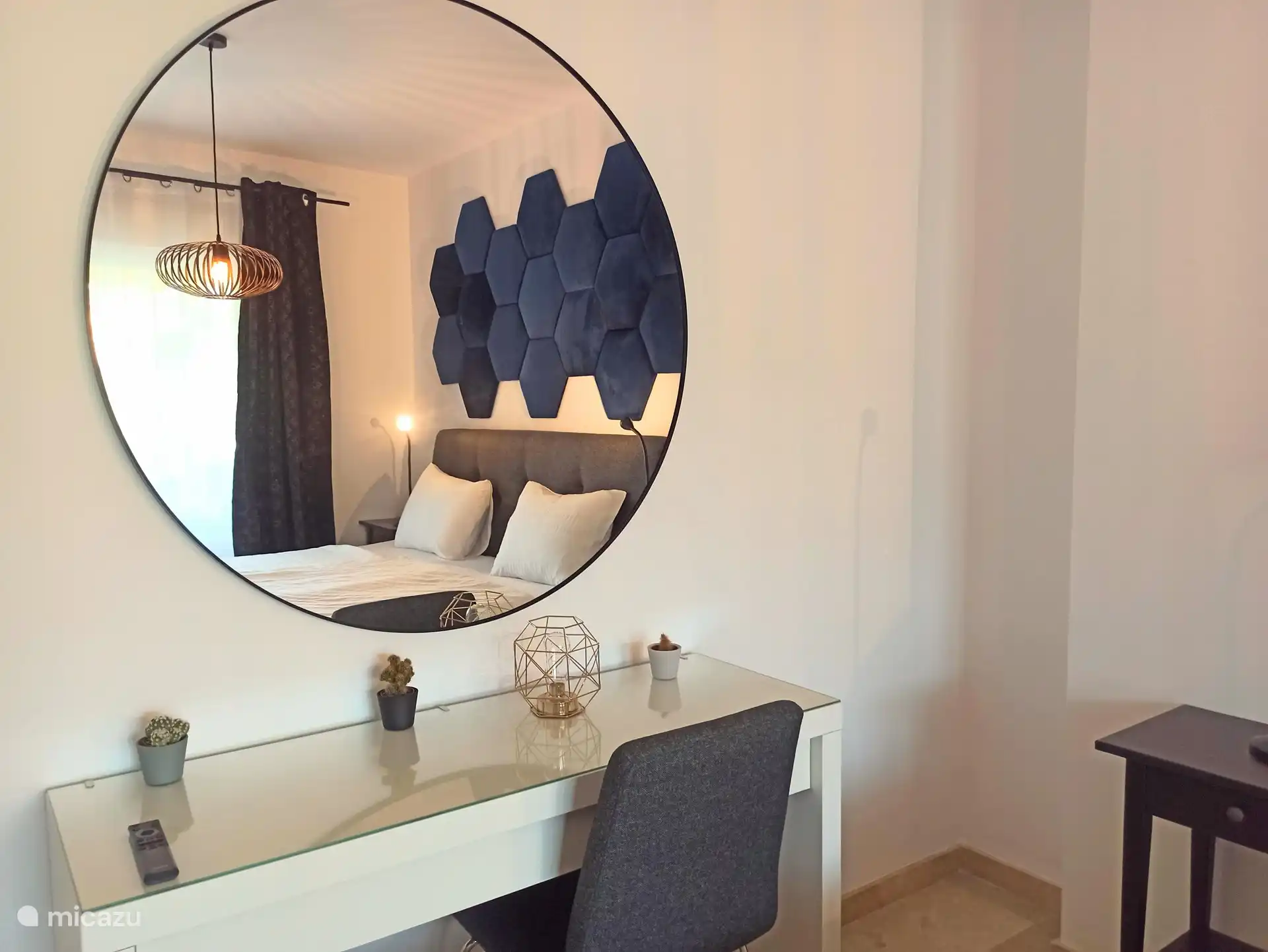 Master bedroom with dressing table and large round mirror