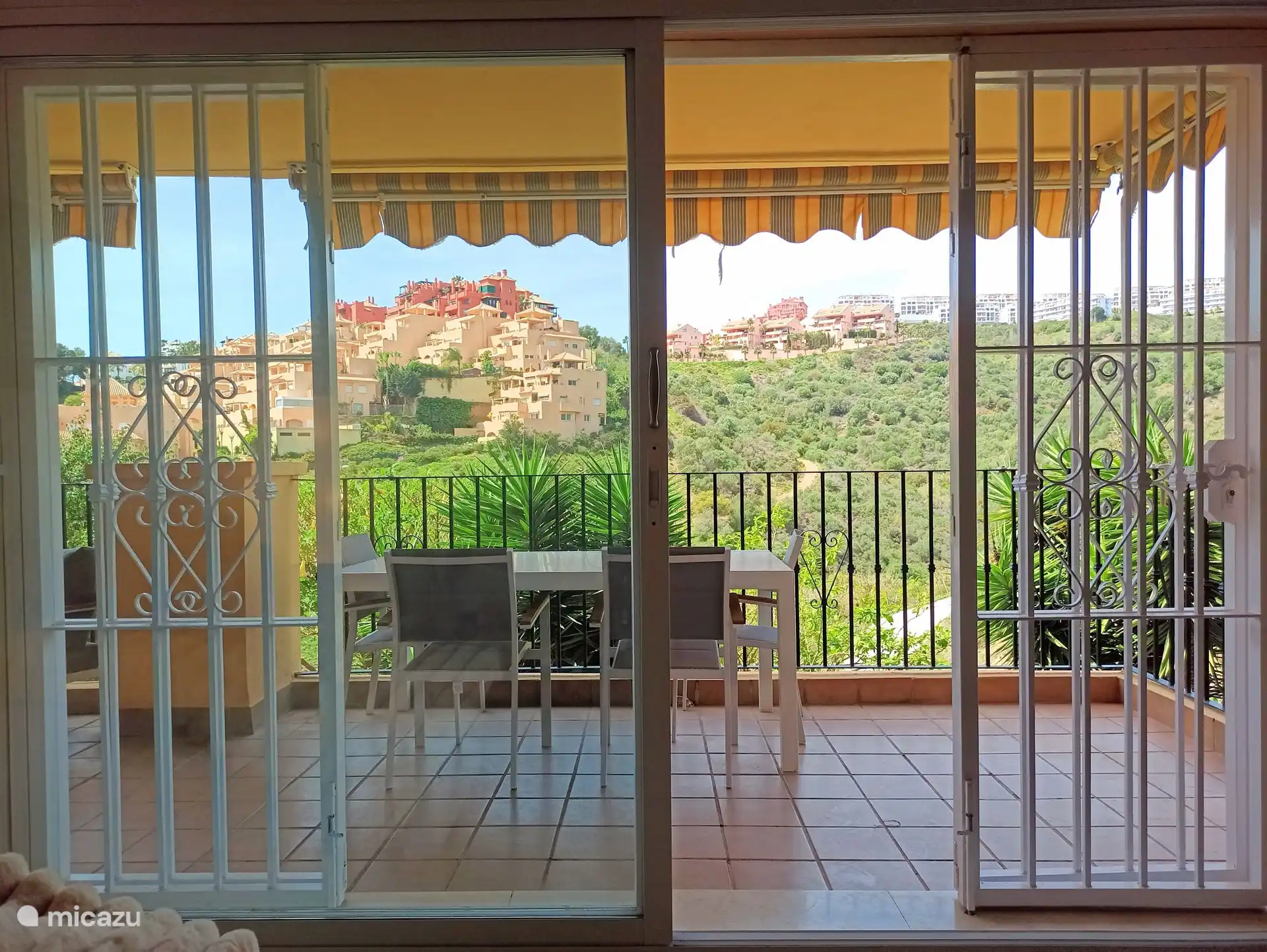 the view of the large terrace with lounge set and dining table for 6 people with unobstructed views and privacy