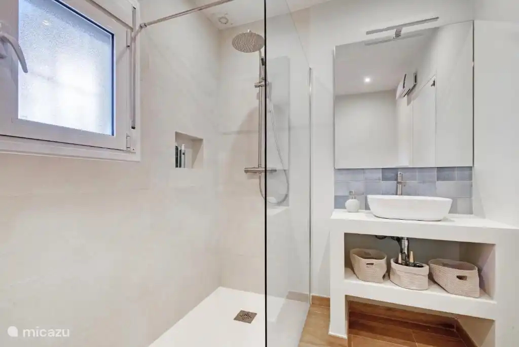 Badezimmer mit Regendusche, WC und Waschbecken