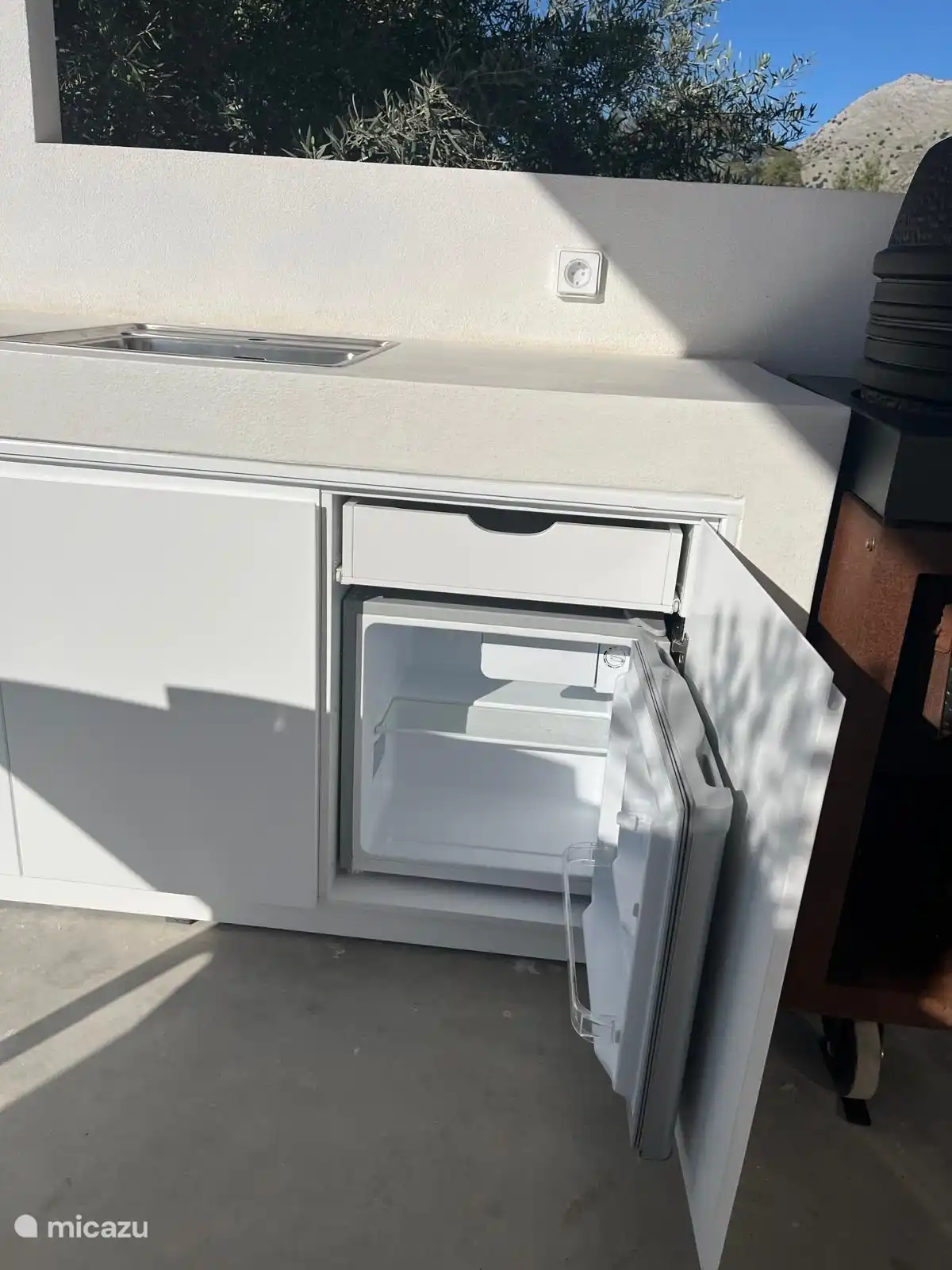 Small fridge in the outdoor kitchen.