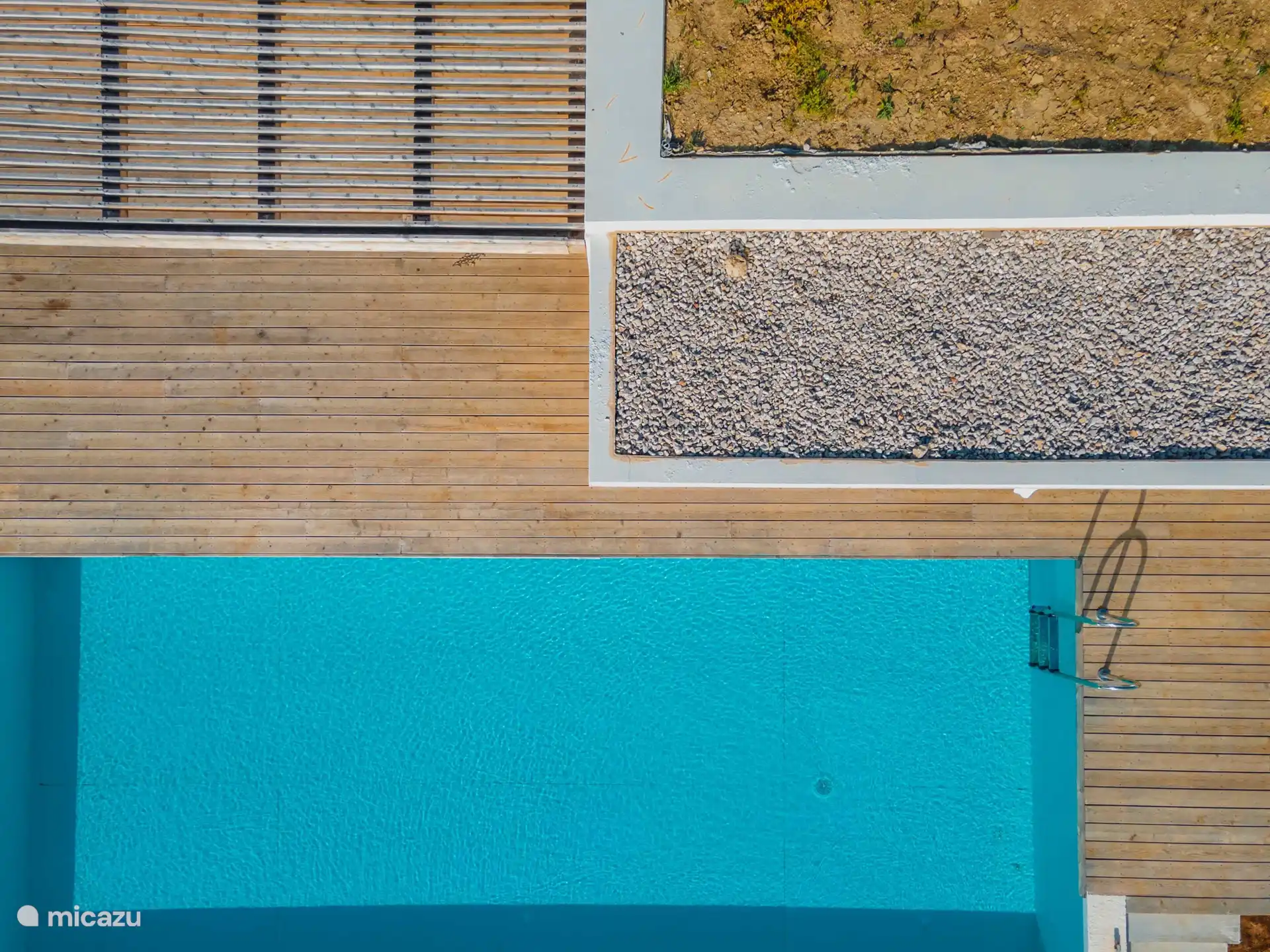 Sun terrace and swimming pool seen from above.