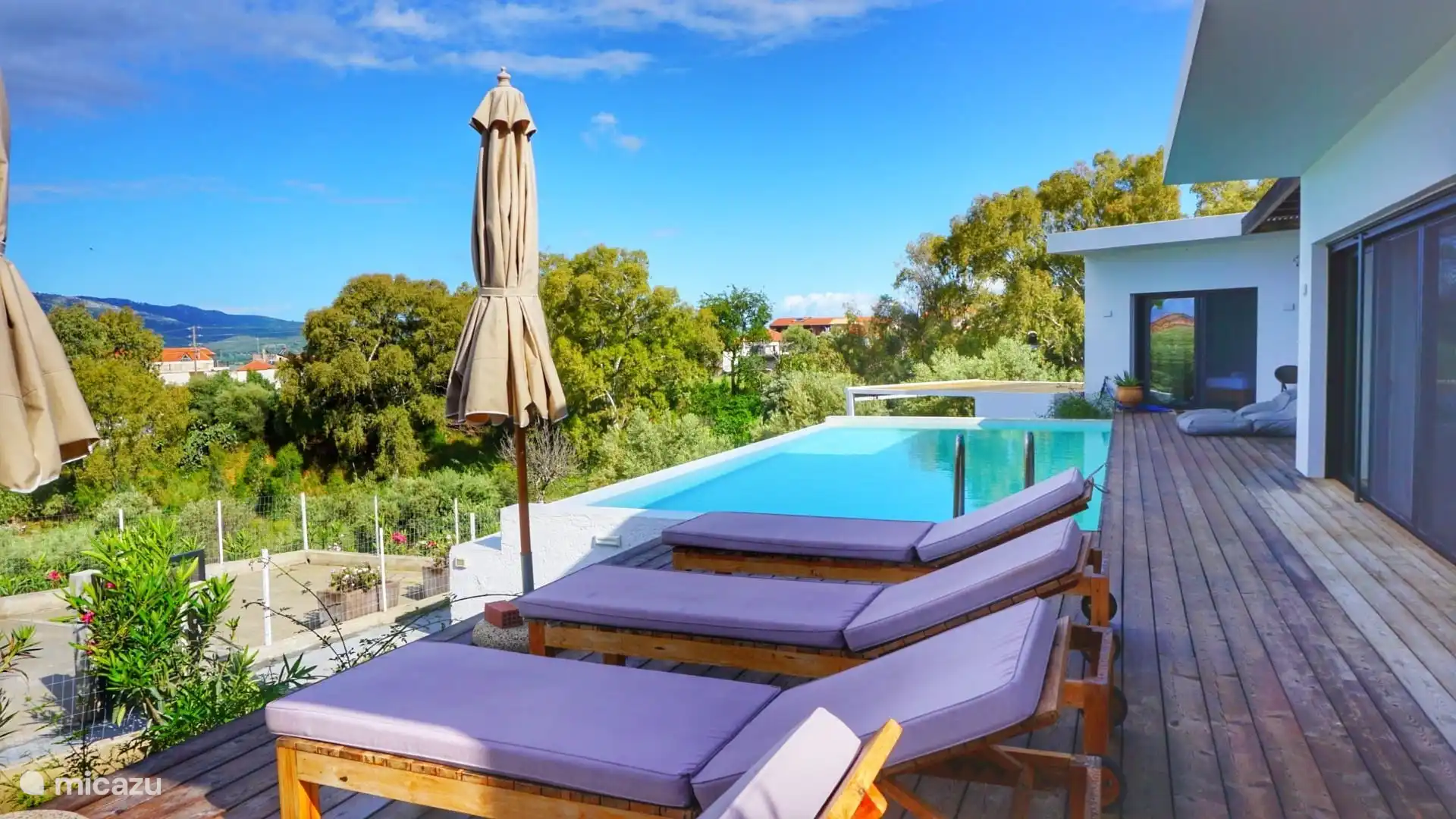 sun terrace with parasol and sunbeds