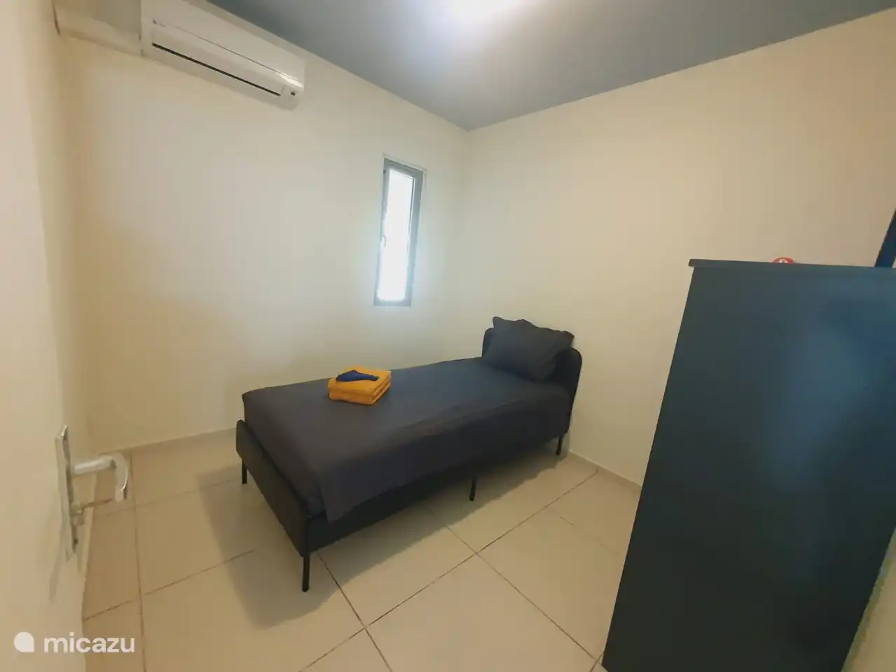 Bedroom 2 with single bed and cupboard for towels and bed linen