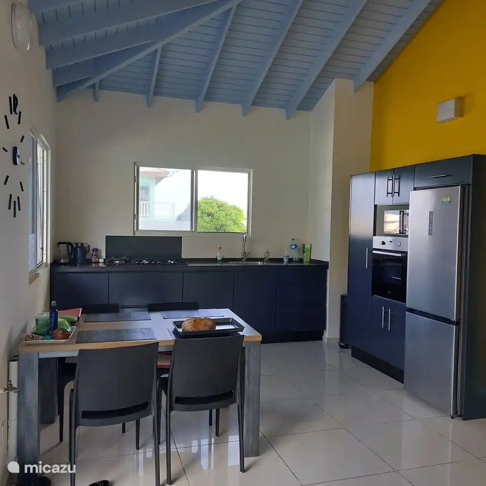 Kitchen with dishwasher, oven and microwave and dining table