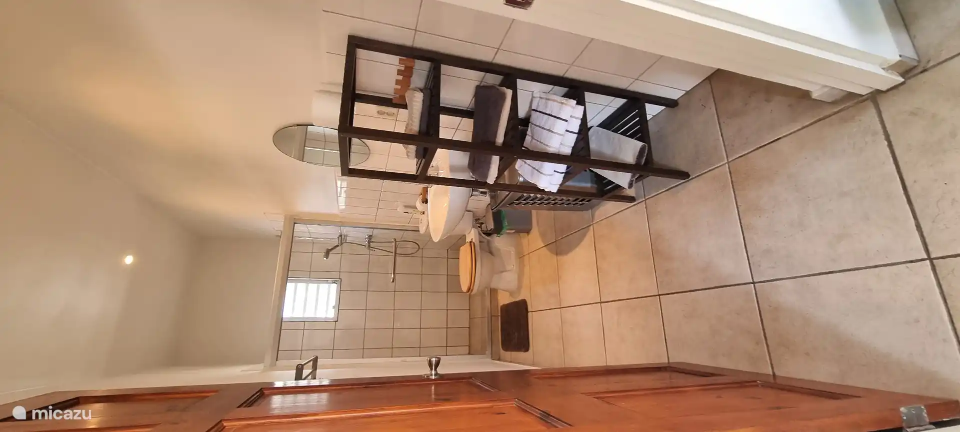 The bathroom has a shower with hot water, a sink and toilet