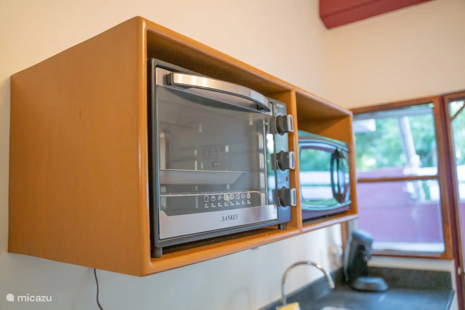 Fully equipped open kitchen with microwave, oven, refrigerator, hob and all the necessities to cook yourself during your stay.