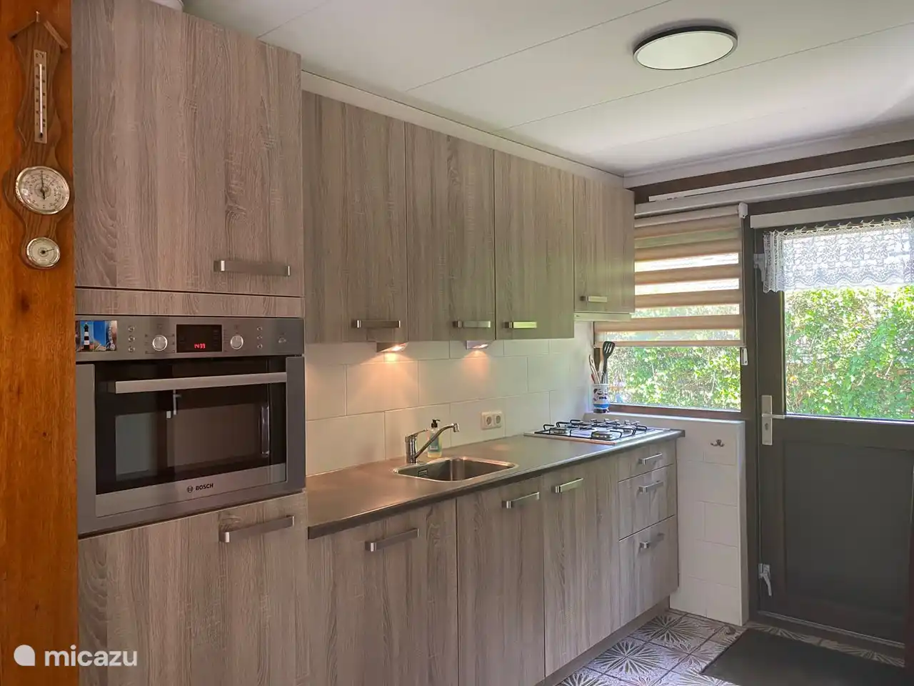 Die Küche ist mit einer Kombi-Mikrowelle, einem Kühlschrank, einem Wasserkocher, einer Nespresso-Kaffeemaschine und einem Gasherd ausgestattet