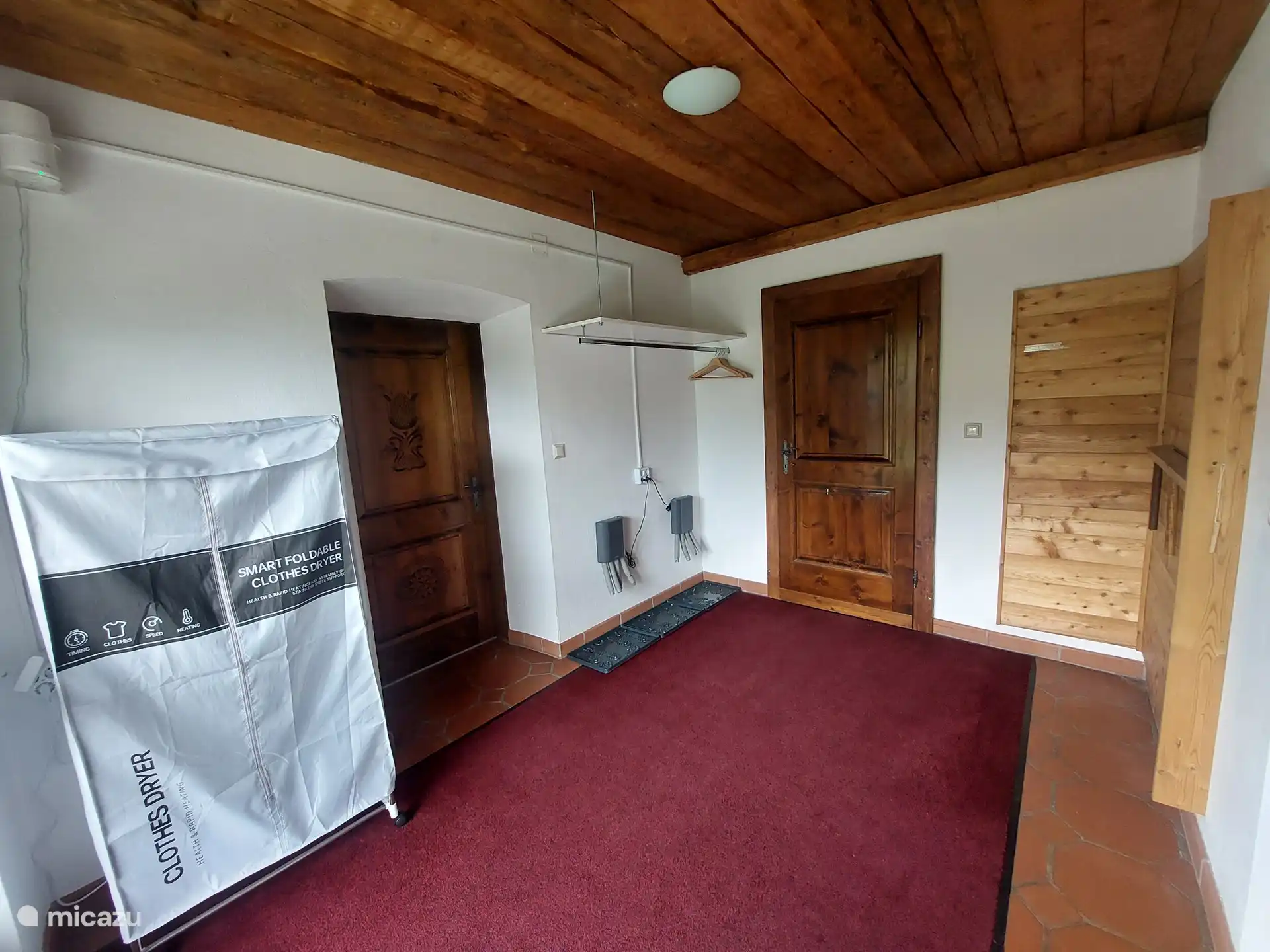 Hall de recepción con espacio para esquís y zapatos, o dos bicicletas.