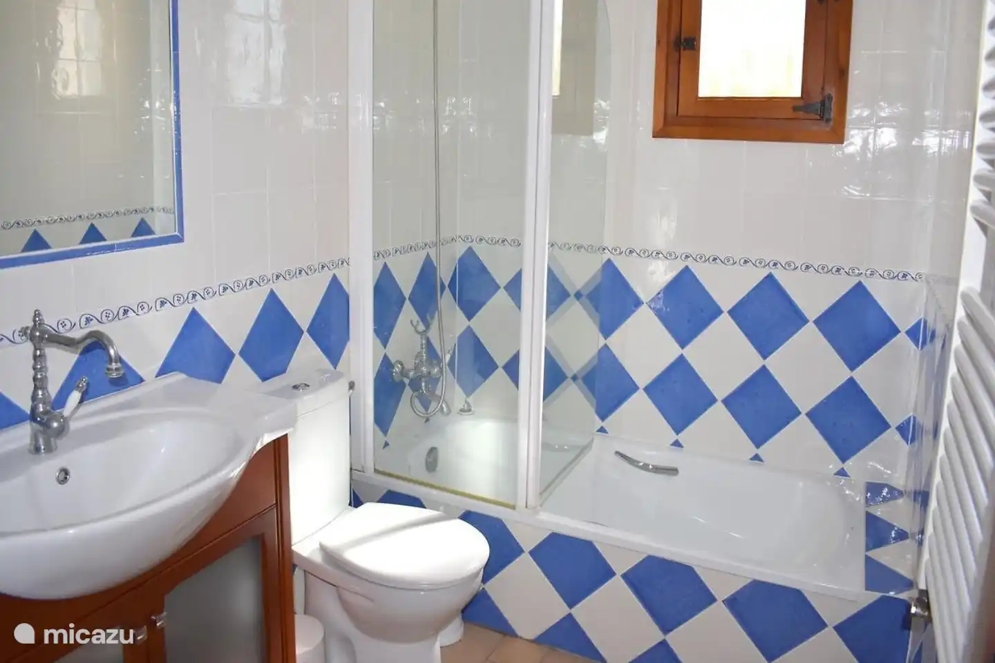 Badezimmer mit Badewanne, Toilette und Waschbecken.