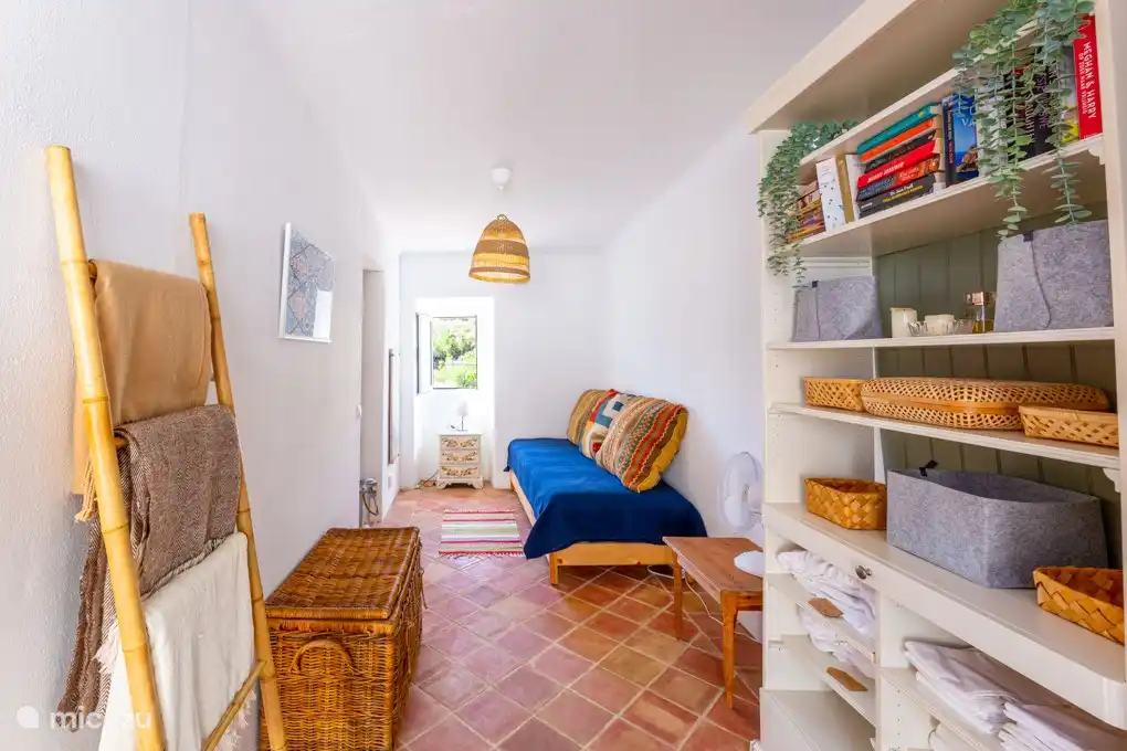 2e slaapkamer met een tweepersoons slaapbank. Openslaande deuren naar de patio.