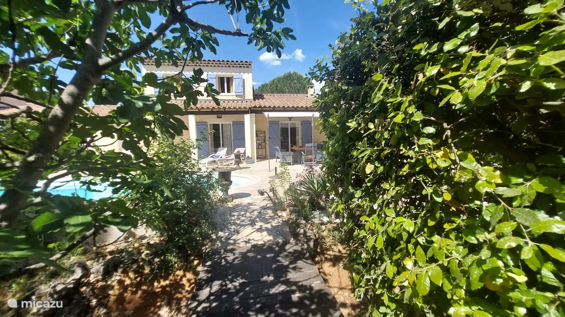 View from the garden to the house and pool