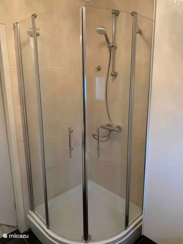 The bathroom has a nice shower. Clean towels are already provided.