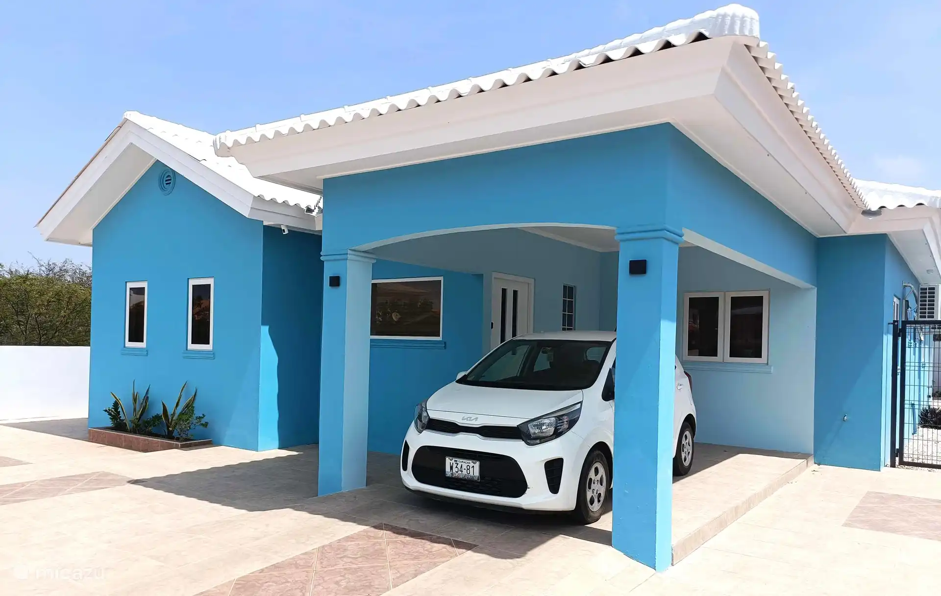 The car is on site in the shade.