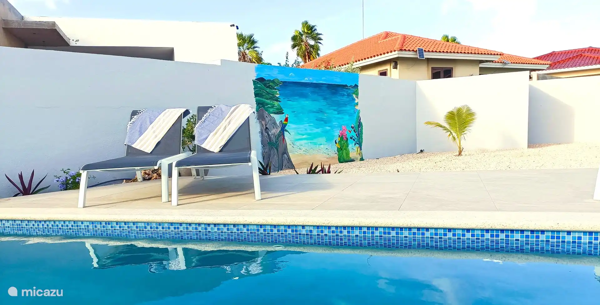 Garden with mural and pump house.