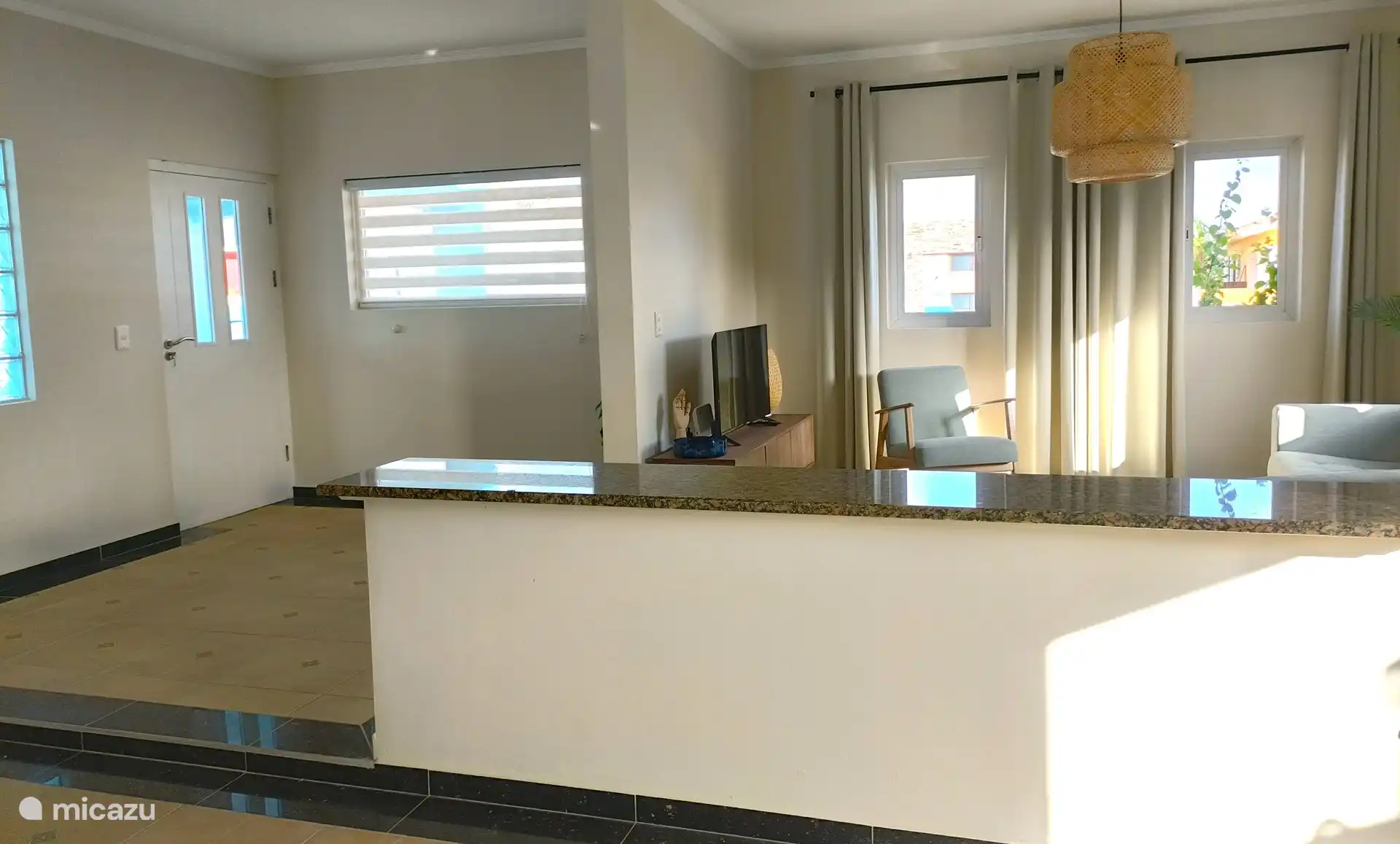 Entrance door, you enter the hall / living room.  Between living room and kitchen a low bar area.