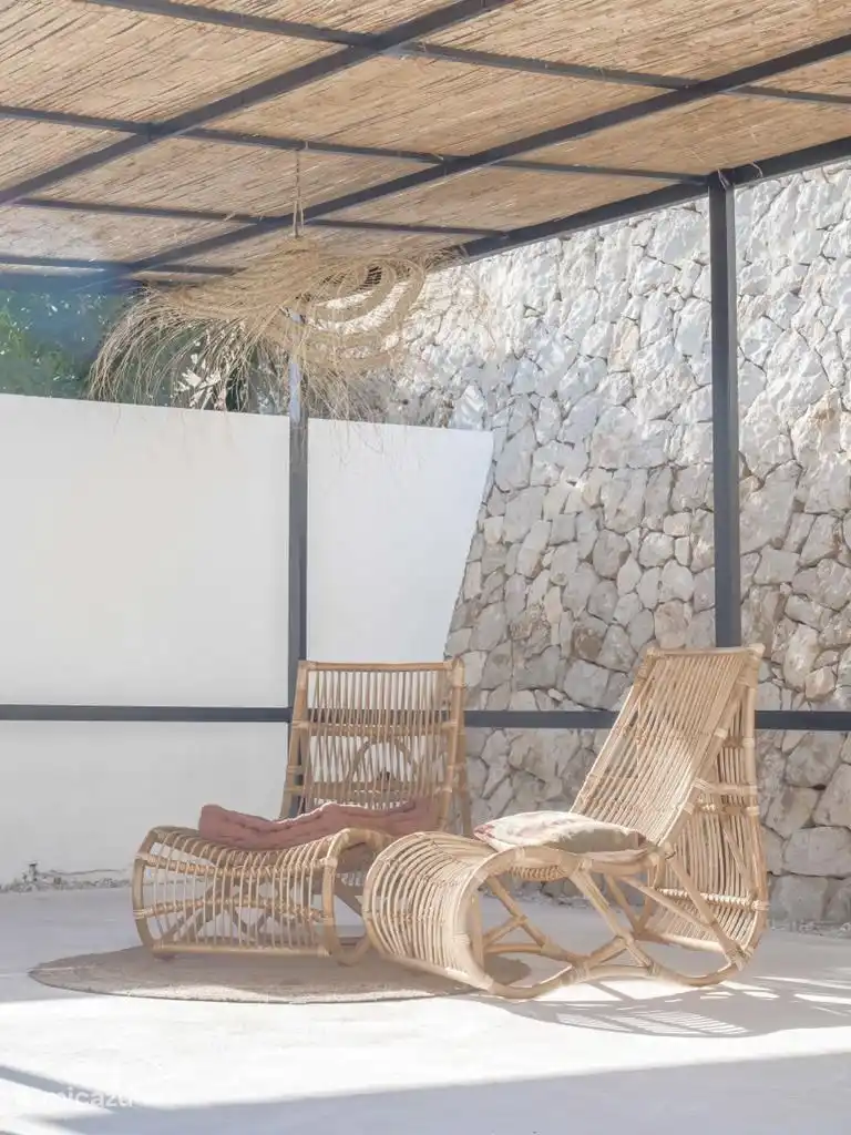 Pergola with 2 lounge chairs.