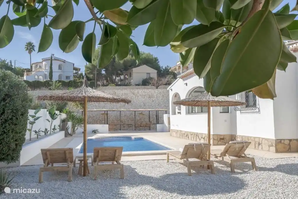 Wooden sunbeds with cushions.