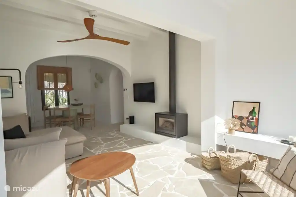 Lounge with fireplace and TV.