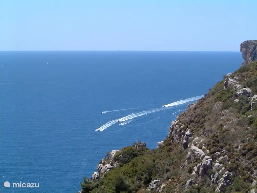 Kijk uit over de zee en kijk naar de boten en jetski's die voorbij varen!