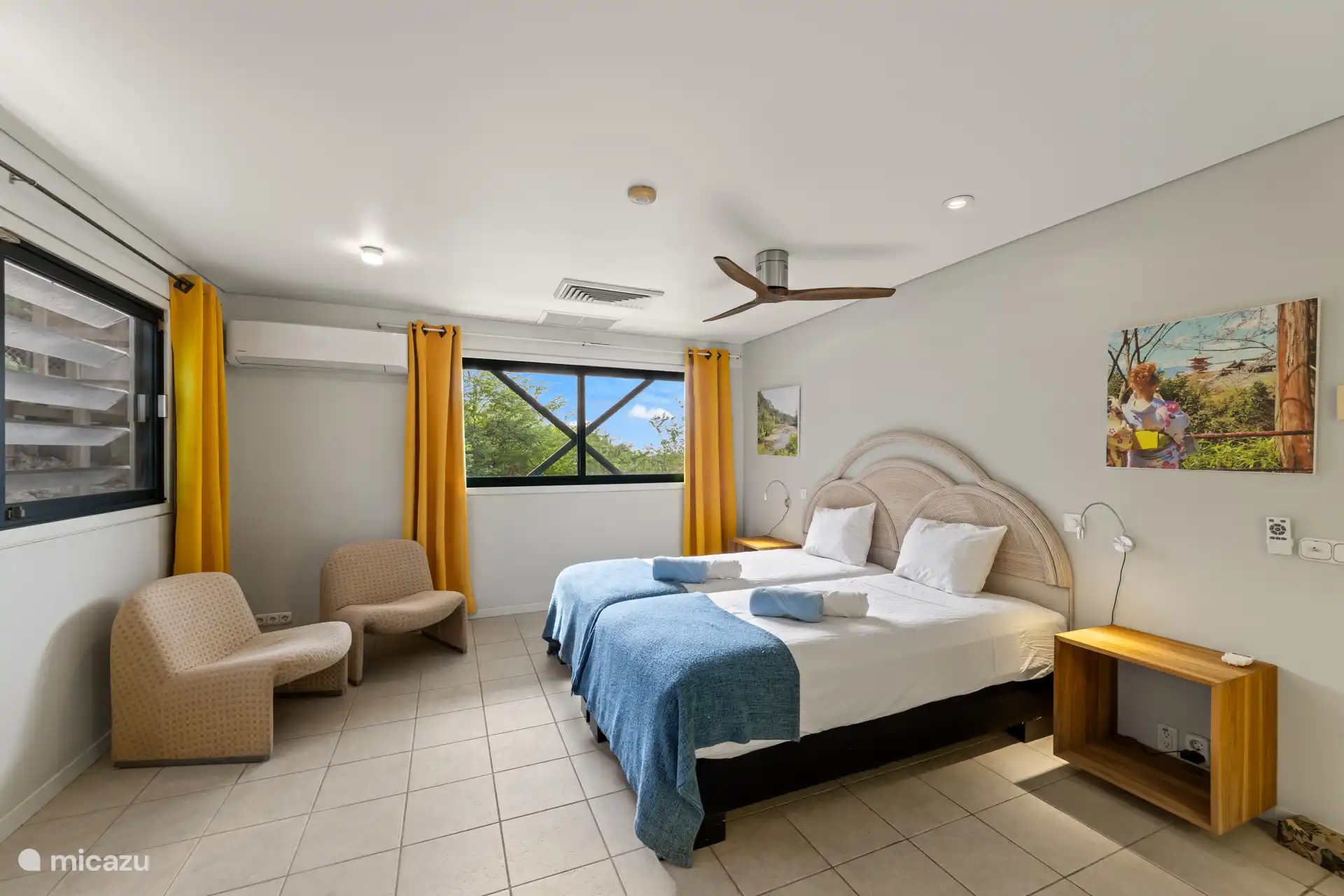 Chambre principale avec climatisation, dressing et salle de bain privée.