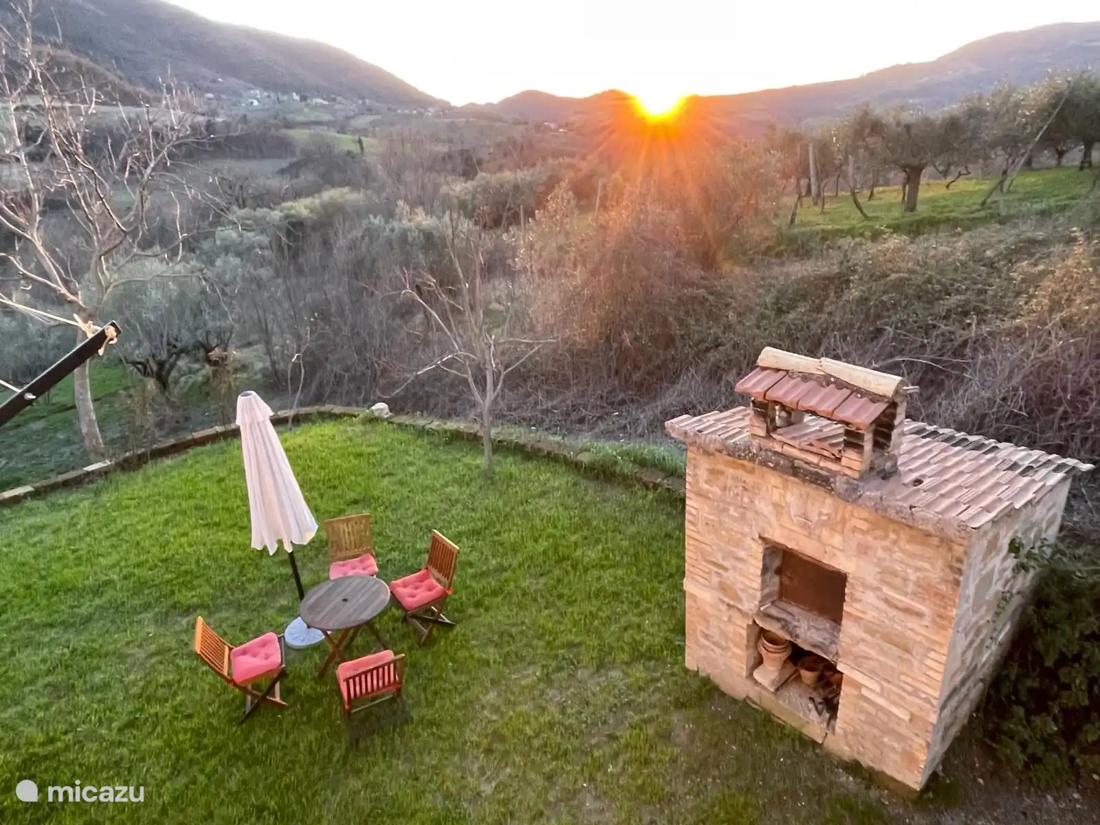 from the balcony, the garden and pizza oven looking to the west with the sun setting
.
