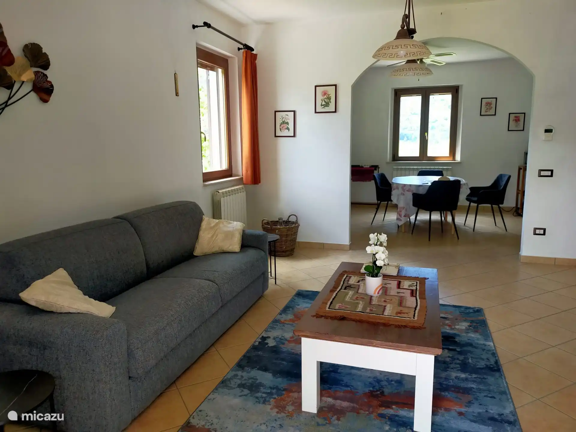 The living room looking at the kitchen, with views over the nature reserve.