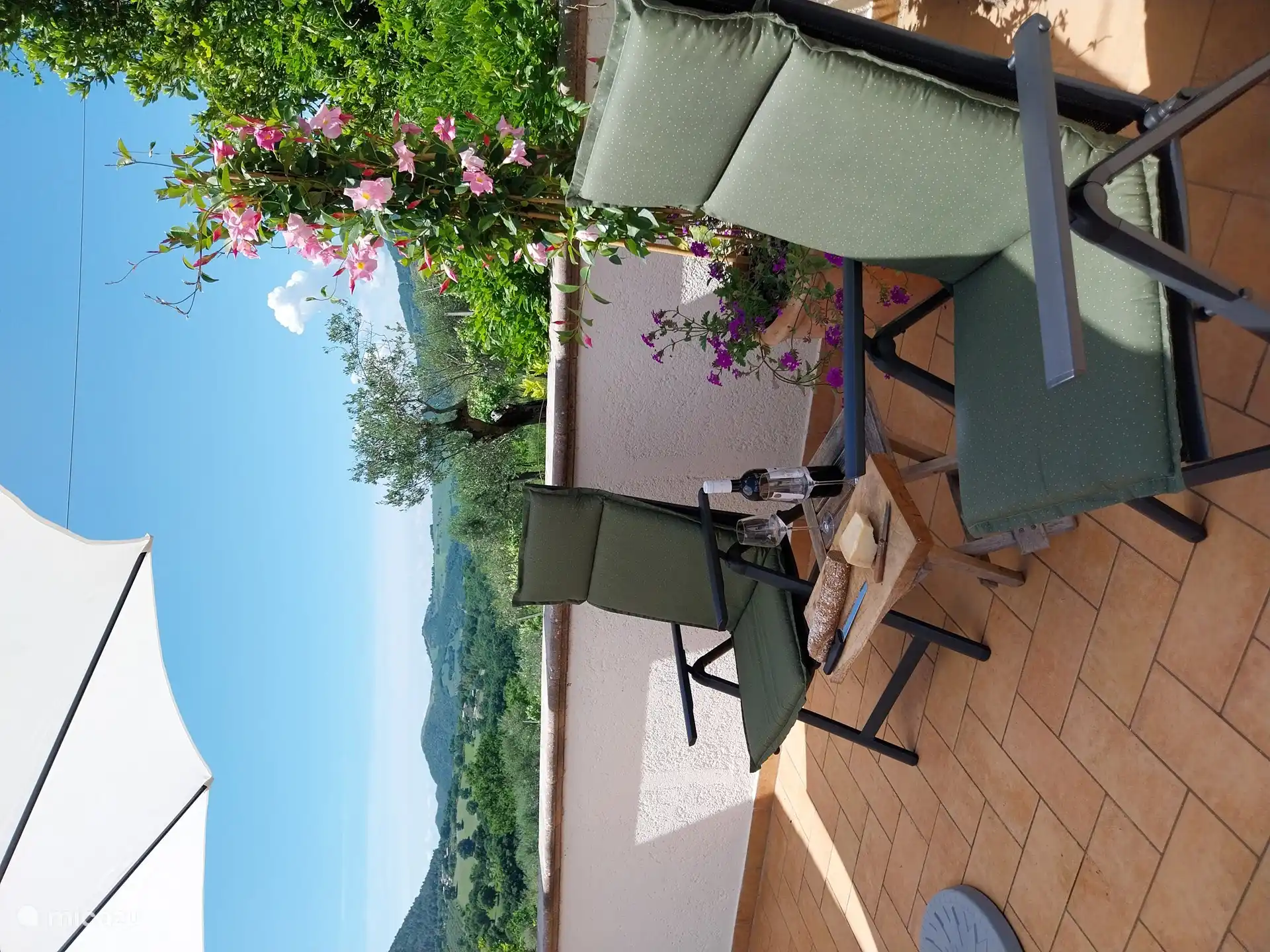 the terrace with panoramic views to several sides, here to the west towards Assisi, with the setting sun.
