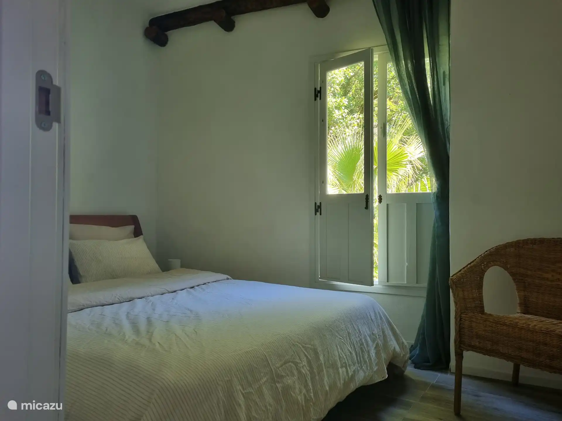 Schlafzimmer Nr. 1 mit Doppelbett (1,50 x 2,00m) und Blick in Garten und Felsen