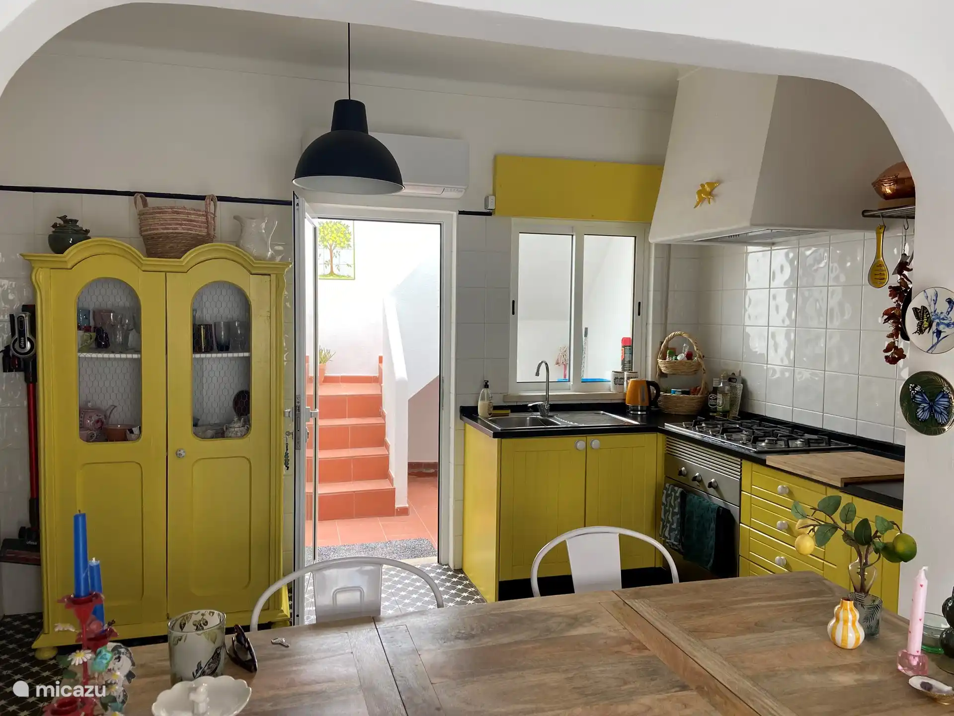 The kitchen with the stairs to the roof terrace behind it