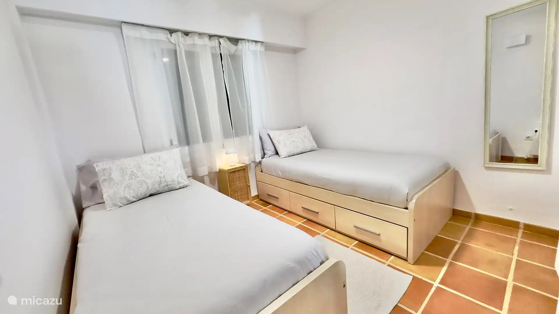 Second bedroom with ceiling fan, heating and ample storage space