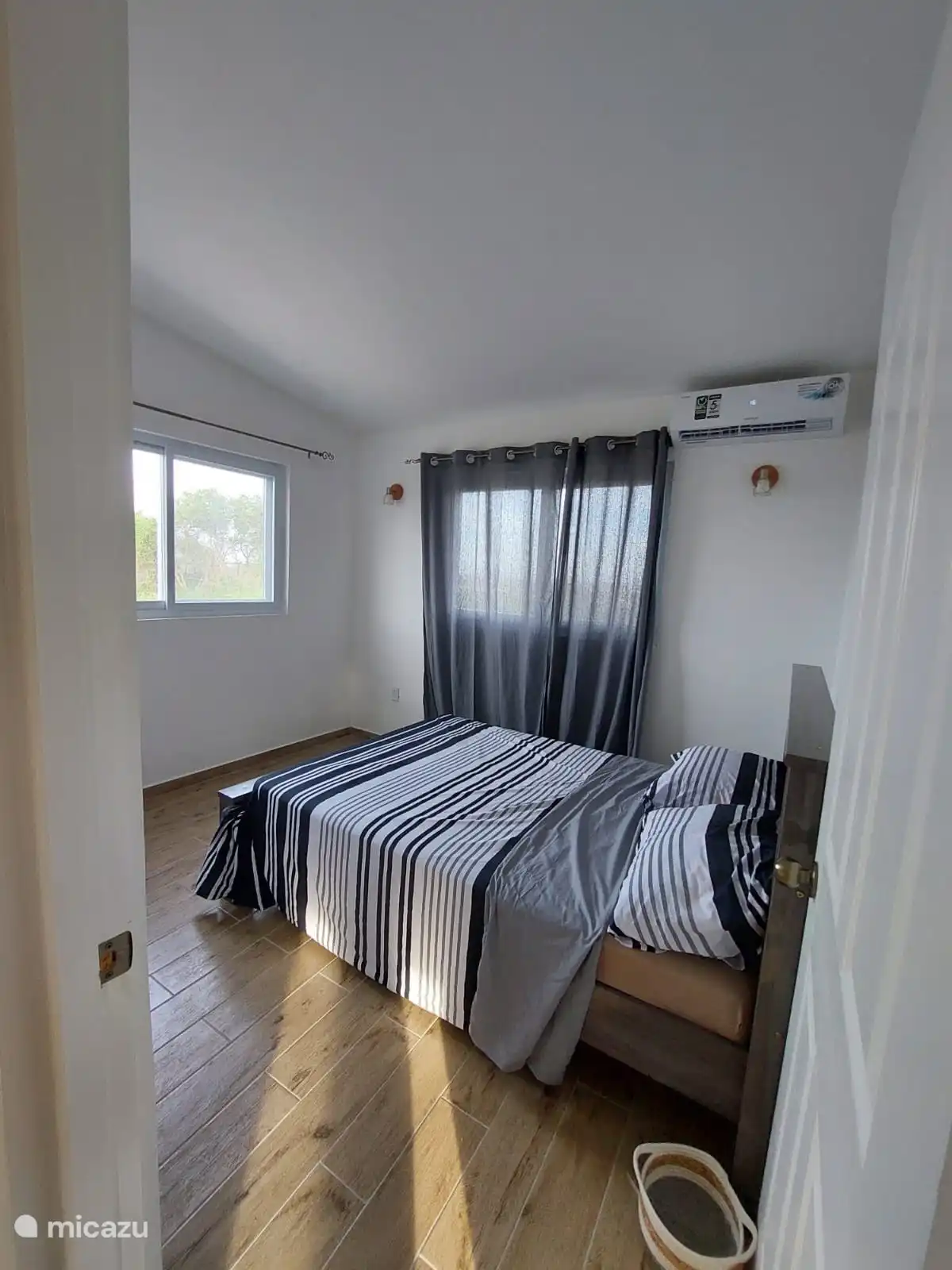This is the bedroom at the front of the apartment. Fresh and a light look.