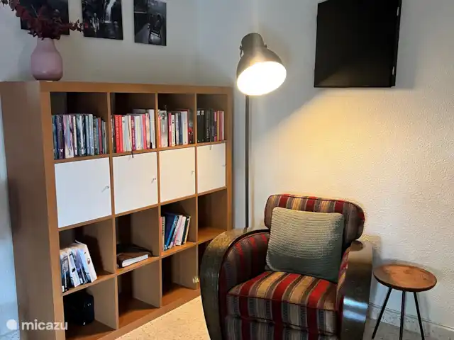 Casa Prima huren in Spanje, Costa Blanca, Alfáz del Pi - appartement Deze stoel mag dan geen schoonheidsprijs winnen, maar wacht maar tot je erin zit – wat een genot! Met een kast vol boeken ernaast hoef je je hier zeker niet te vervelen. En voor de darters: schuif de stoel even opzij en gooi een pijltje. Klaar voor een potje? ??